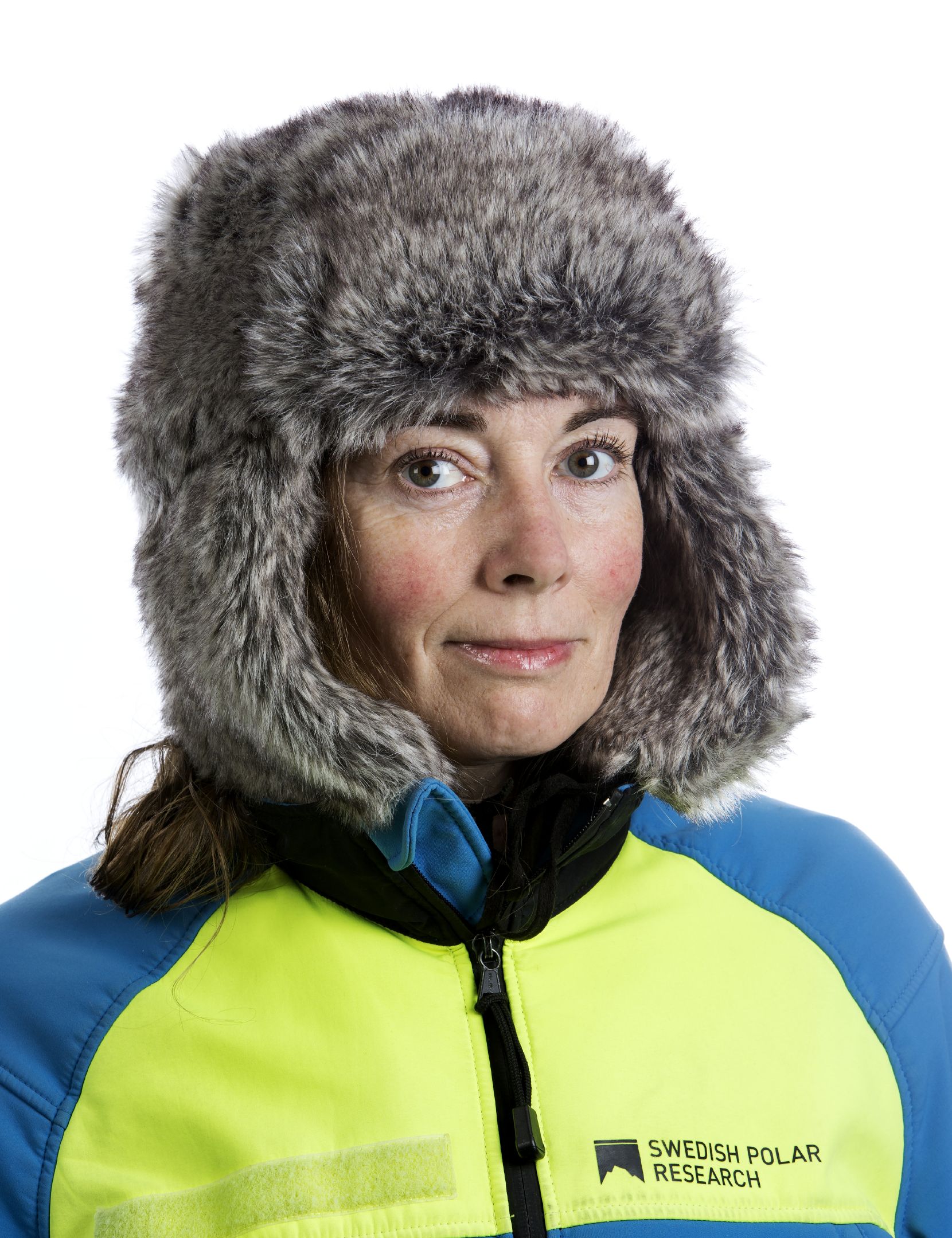 Porträtt av Anna Wåhlin. Hon har blå och gul jacka och pälsmössa. 